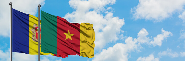 Andorra and Cameroon flag waving in the wind against white cloudy blue sky together. Diplomacy concept, international relations.
