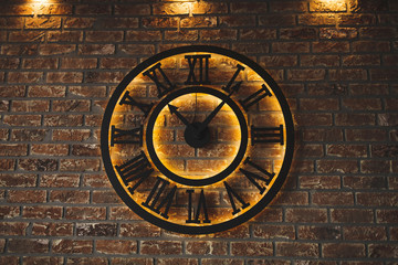 Fototapeta na wymiar black luminous clock on brick background