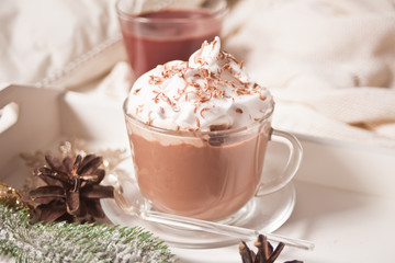 Cup of cocoa on the white tray on the bed early winter morning