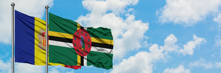Andorra and Dominica flag waving in the wind against white cloudy blue sky together. Diplomacy concept, international relations.