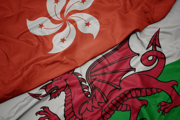 waving colorful flag of wales and national flag of hong kong.