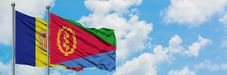 Andorra and Eritrea flag waving in the wind against white cloudy blue sky together. Diplomacy concept, international relations.