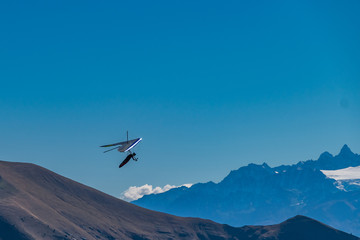 Naklejka na ściany i meble Hang-gliding in Swiss Alps from top of Rochers-de-Naye, near Montreux, Canton of Vaud, Switzerland.