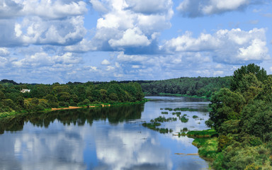 Fototapeta na wymiar Summer landscape with river, cloudy sky, forest and sun