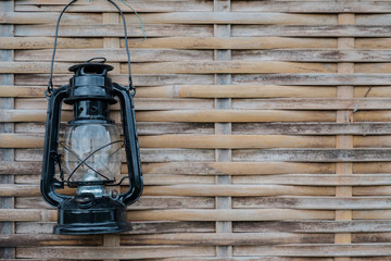 Lamp on bamboo wall.