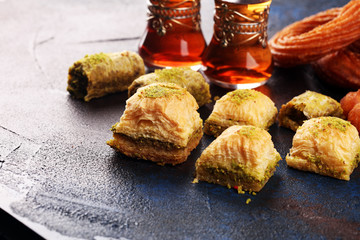 Baklava on table. Middle eastern or arabic dishes. Turkish Dessert Baklava with pistachio on rustic table