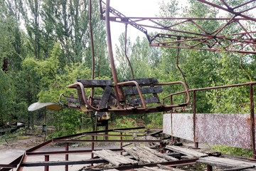 Unhappy childhood. Broken children's swing. Children's park with old broken swings.