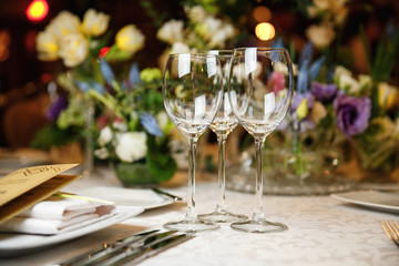 catering at a top event, glasses and flowers on the table, preparation for a significant event, beautiful dishes and glasses on the table, New Year's holiday table