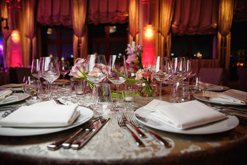 catering at a top event, glasses and flowers on the table, preparation for a significant event, beautiful dishes and glasses on the table, New Year's holiday table