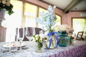 catering at a top event, glasses and flowers on the table, preparation for a significant event, beautiful dishes and glasses on the table, New Year's holiday table