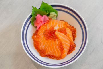 Japanese food Salmon sashimi, salmon's egg (ikura), shredded radish and slice ginger with japanese rice donburi,Salmon don.