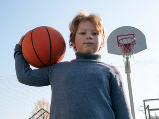 Fototapeta premium boys playing basketball outdoors on a sports field