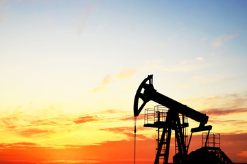 Oil drilling derricks at desert oilfield. Crude oil production from the ground. Oilfield services...