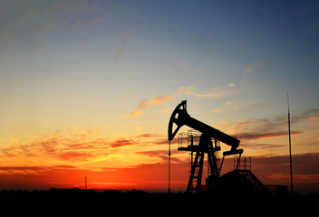 Oil drilling derricks at desert oilfield. Crude oil production from the ground. Oilfield services...