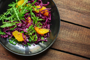 healthy salad orange fillet, red cabbage, arugula (delicious snack, mix leaves lettuce, coleslaw) menu concept. food background. copy space. Top view