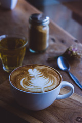 coffee hot drink cappucino latte art on wood vintage table , coffee time on wood background cafe