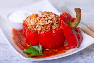 Peppers stuffed with meat, rice and vegetables with tomato sauce and sour cream. A traditional...