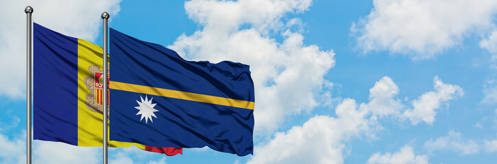 Andorra and Nauru flag waving in the wind against white cloudy blue sky together. Diplomacy concept, international relations.
