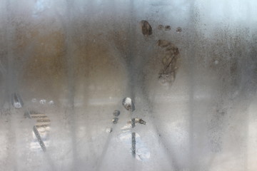  Small marks on the fogged window.