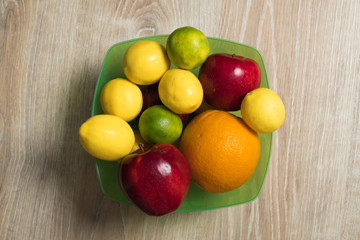 Fruit studio image. Bowl of fruit. Set of citrus fruits and red apples.