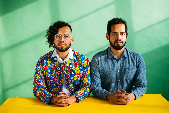 Portrait of Latino twin brothers in studio environment