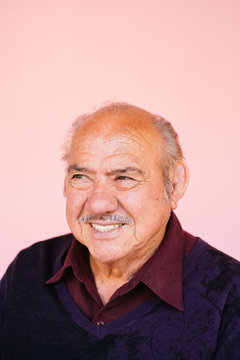 Portrait of eldery Latino grandfather in studio environment