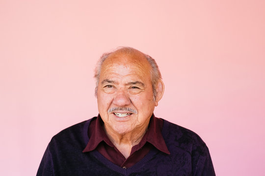 Portrait of eldery Latino grandfather in studio environment