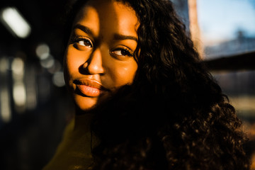 Shadows falling across young woman's face