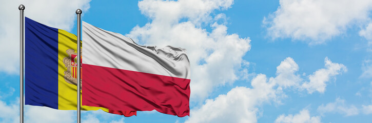 Andorra and Poland flag waving in the wind against white cloudy blue sky together. Diplomacy concept, international relations.