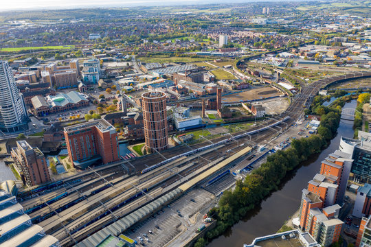 Aerial photo of the Leeds town centre in the UK showing train tracks along the city centre