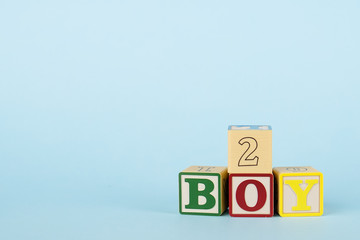 Blue background with colored cubes with letters Boy and number, baby development and toys for toddlers