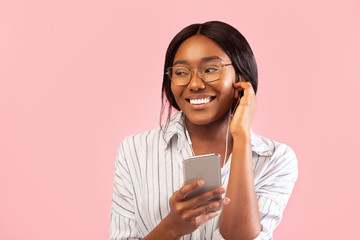Cheerful Black Girl Standing Using Phone Listening Music, Studio Shot