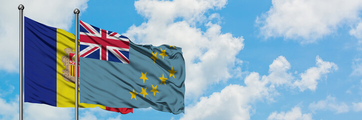 Andorra and Tuvalu flag waving in the wind against white cloudy blue sky together. Diplomacy...