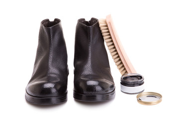 Men's shoes and care products. Tools for shoes. Shoe brushes and creams. A pair of shoes and cream with a brush on a white background.