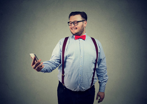 Funny chubby guy taking selfie with cell phone