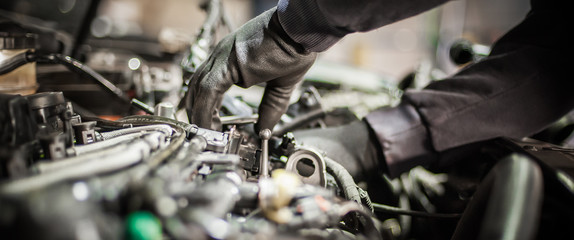 Fototapeta Close up of car mechanic repairer technician repairs auto engine obraz