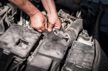 Close up of car mechanic repairer technician repairs auto engine