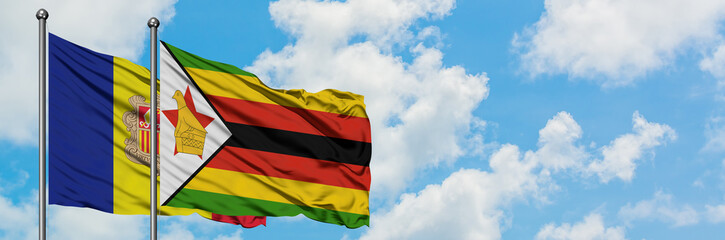 Andorra and Zimbabwe flag waving in the wind against white cloudy blue sky together. Diplomacy concept, international relations.