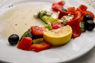 assorted pickles in a plate. Tomatoes, cucumbers, carrots, cabbage close-up.