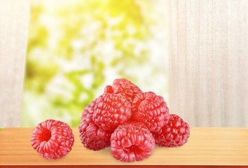 Fresh red raspberries food on wooden desk