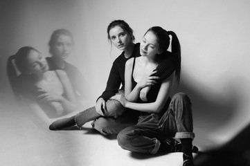 Two gorgeous girl in studio.Fine art.Fashionable. Sensuality.