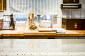 Kitchen table top with kitchen accessorries and empty space for you products or decorations. Blurred kitchen background.