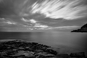 Fototapeta premium Dramatic seascape view in black and white long exposure, dark, scenic picture.