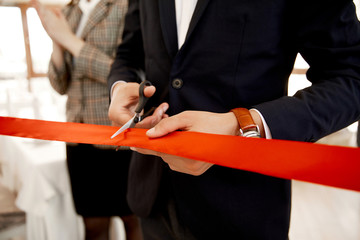 Front view of the cutting the red ribbon on the grand opening of the building - obrazy, fototapety, plakaty