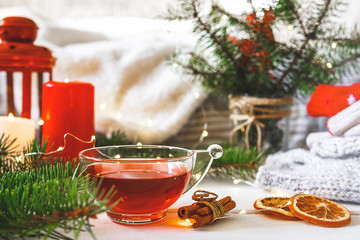 Cozy autumn  winter home, Christmas eve. Cup  tea, autumn garland on a wooden table near the bed with warm plaids. Autumn lifestyle lagom hygge.holiday and a weekend in the fall in winter on holidays.