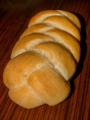 Fresh homemade knitted bun on wooden background