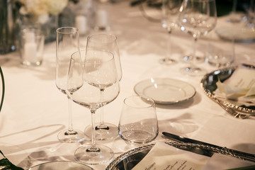catering at a top event, glasses and flowers on the table, preparation for a significant event, beautiful dishes and glasses on the table, New Year's holiday table
