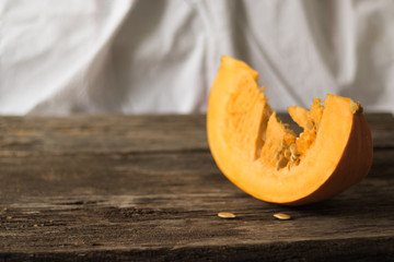 Fresh pumpkin on the table from old boards. Horizontal orientation, copy space and white background.