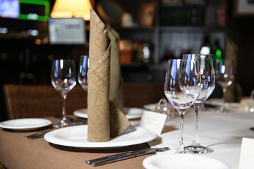 catering at a top event, glasses and flowers on the table, preparation for a significant event, beautiful dishes and glasses on the table, New Year's holiday table