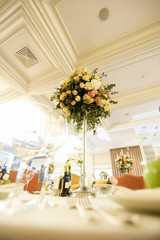 catering at a top event, glasses and flowers on the table, preparation for a significant event, beautiful dishes and glasses on the table, New Year's holiday table